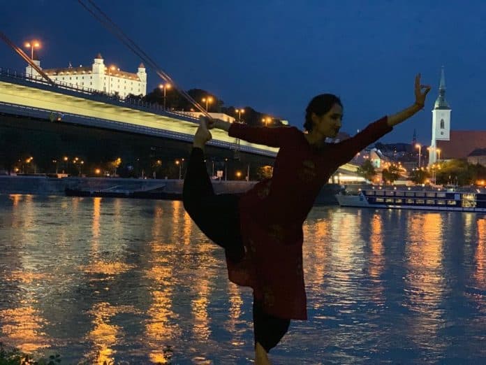 Jaiwanti in dancer pose by the Danube at night, Bratislava